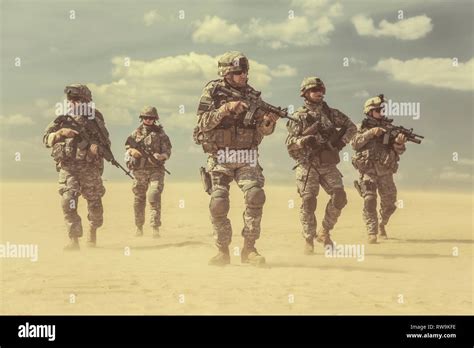Team Of United States Airborne Infantry Men Patrolling The Desert Storm