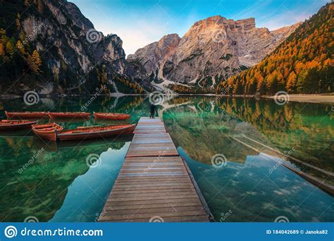 Photographer Tourist On The Pier Of Lake Braies Dolomites Italy Stock