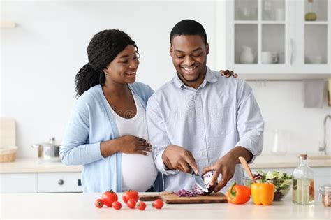 Happy African American Pregnant Couple Cooking Together Kitchen