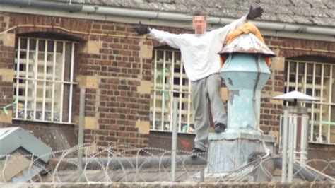 inmate makes hand gestures after climbing on prison roof in 24 hour standoff lbc