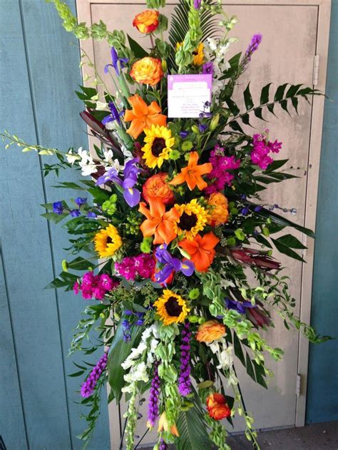 Colorful Standing Funeral Spray With Sunflowers Orange Roses And