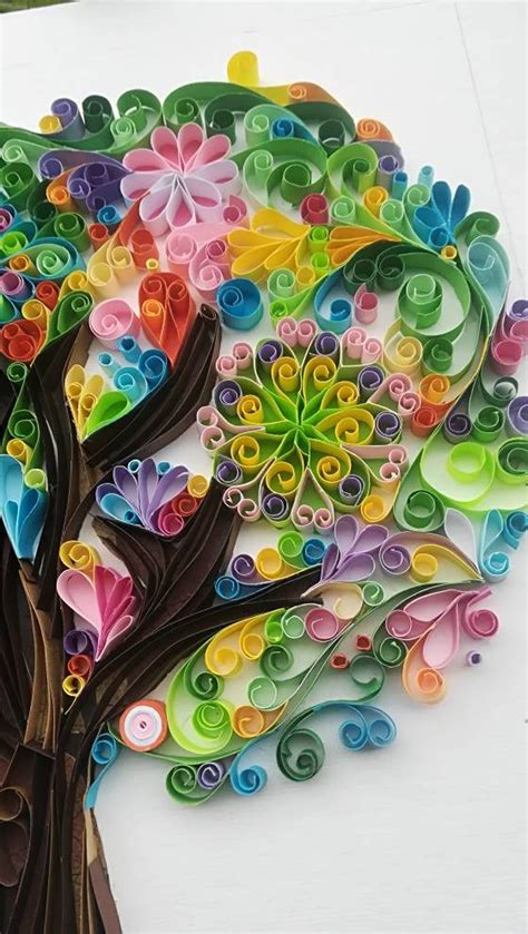A Tree Made Out Of Rolled Up Paper With Colorful Circles On The Leaves