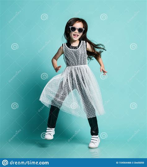 Cheerful Stylish Asian Baby Girl Kid In Modern Black And White Clothes