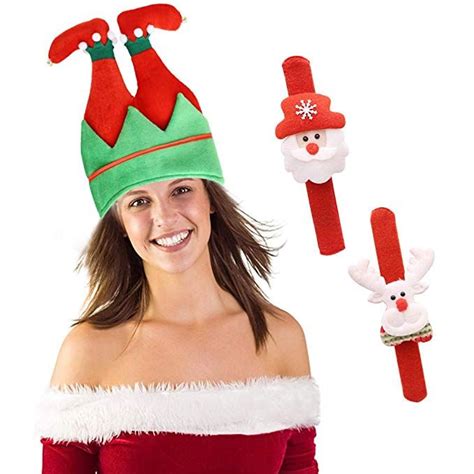 A Woman Wearing A Santa Clause Hat And Holding Two Christmas Hair Clips