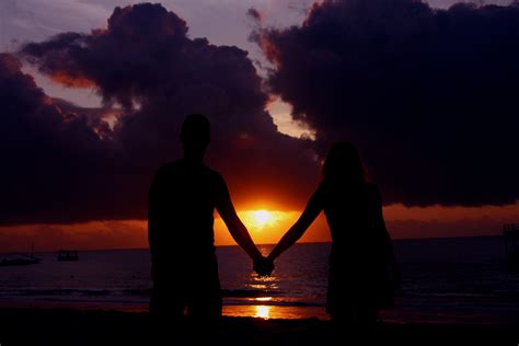 Couples In The Sunset Holding Hands