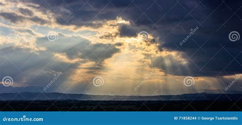 Stormy Clouds With Radiating Sunbeams Stock Photo Image Of Moody