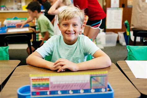 Smiling Student Sitting At His Desk By Stocksy Contributor Kelly