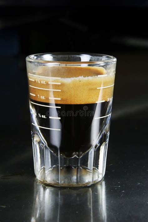 Cup Of Espresso Single Shot On Wooden Table With Coffee Bean Scattered
