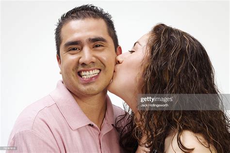 Young Woman Kissing Mature Man On Cheek Smiling Photo Getty Images