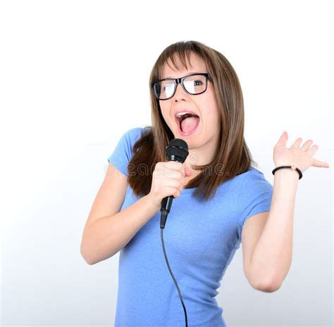 Portrait Of A Young Female With Microphone Against White Background