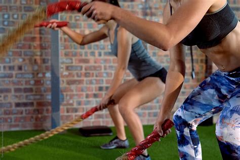 Women Doing Exercises With Ropes At A Gym By Stocksy Contributor