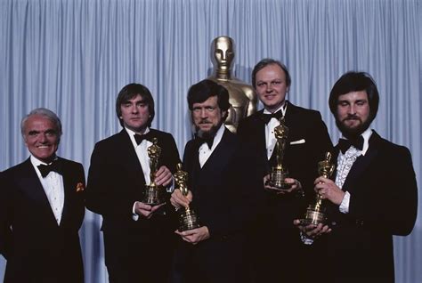 Four Men In Tuxedos Pose With Their Oscars For The Films Best Director
