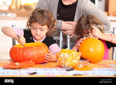 Children Carving Halloween Pumpkins Stock Photo Alamy
