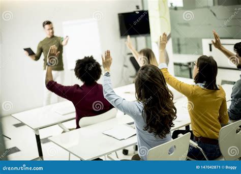 Students Rising Hands To Answer The Question During The Workshop