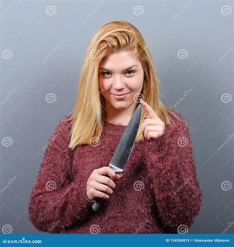 Portrait Of Killer Woman With Knife Against Gray Background Stock Image