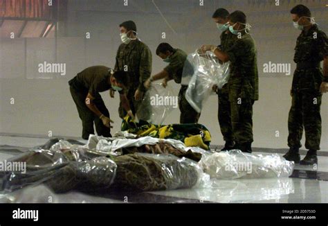turkish soldiers line up dead bodies of victims of the heavy quake in the ice stadium of izmit