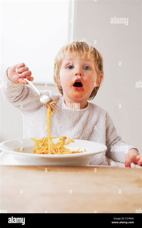 2 Year Old Boy Eating Spaghetti Stock Photo Alamy