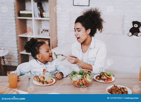 Mother Feeds Young Girl Mom And Daughter Eat Stock Image Image Of Chicken Mulatto 127297233