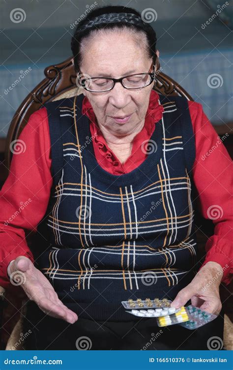 Portrait Of An Elderly Woman With A Beautiful Wrinkled Face In Glasses