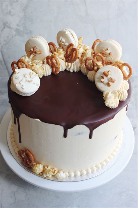 Chocolate And Peanut Butter Cake Decorated With Macarons Popcorn And