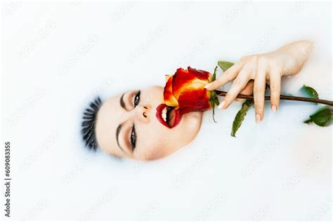 Portrait Of Sexy Girl In A Bath With Milk Beauty Woman With Bright Red Lips And Rose Flower