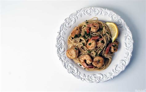 Sauteed bay scallops with tomatoes and a touch of white wine and lemon juice served over angel hair pasta. Seafood Scampi with Angel Hair Pasta - Pass The Sushi