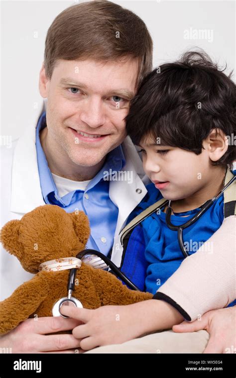 Friendly Doctor Playing With Five Year Old Disabled Patient During
