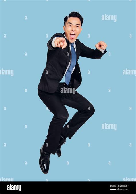 Excited Young Businessman Jumping In Air Stock Photo Alamy