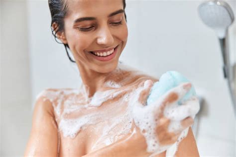 Beautiful Lady With Foam On Her Skin Washing Body With Bath Sponge And