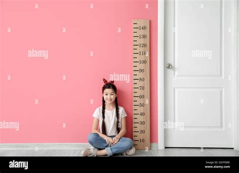 Little Girl Measuring Height Near Color Wall Stock Photo Alamy