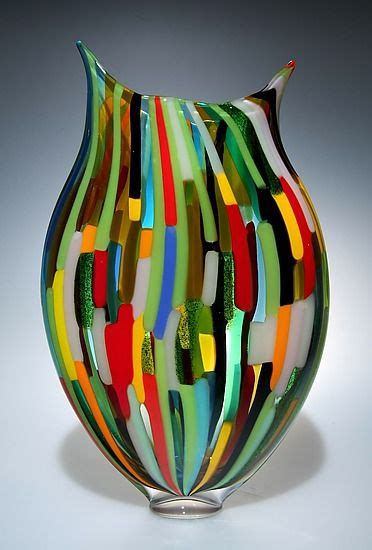 A Multicolored Glass Vase Sitting On Top Of A Table