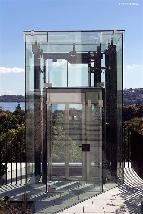 A Glass And Metal Structure On The Side Of A Hill