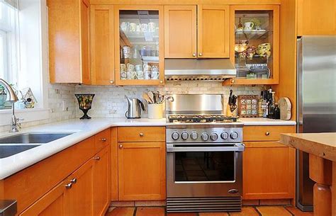 Wide view of oak kitchen cabinets, a wood floor, stainless kitchen appliances, and empty countertop. Gallery: Heritage home in Kitsilano, Vancouver -- $2.588M ...