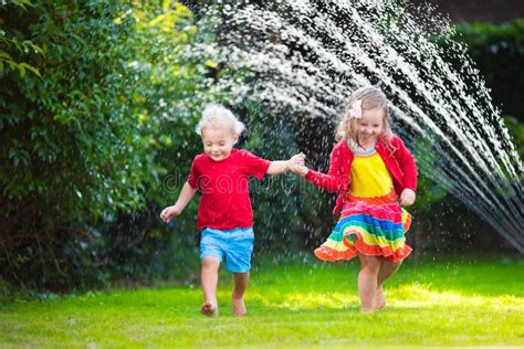 Kids Playing With Garden Sprinkler Stock Photo Image 59264551