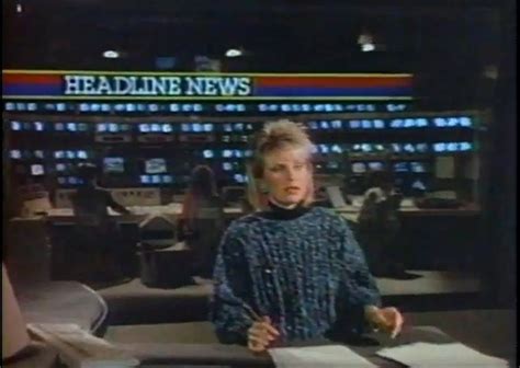 A Woman Standing In Front Of A News Desk
