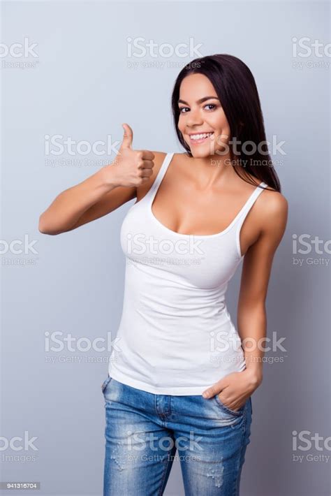 Cute Hispanic Girl Is Shwing Like Sign On Light Blue Background In
