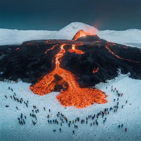 Tourists Watch A Volcano Erupt On Iceland Arnar Kristjansson R
