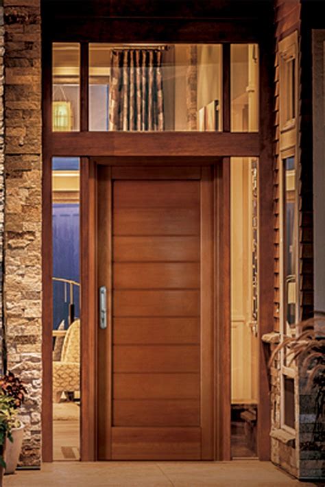 Revestimientos símil piedra puerta de entrada de madera La casa de