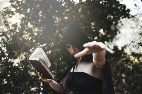 Free Photo Witch With Spellbook Using Magic In Sunlit Woods