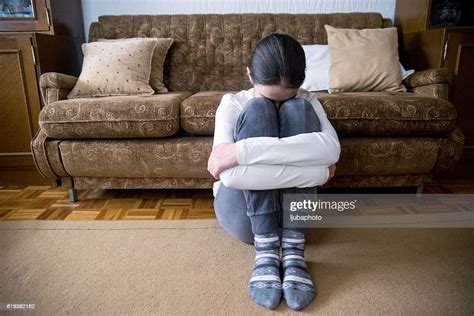 Girl With Lower Head On Her Knee Sitting Beside Bed Photo Getty Images