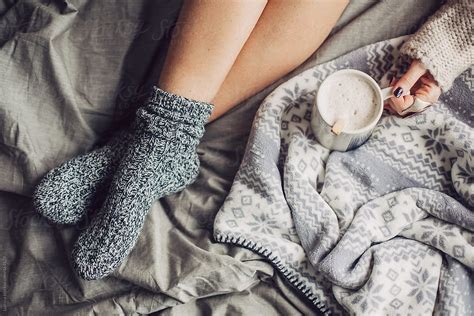 Woman In Woolen Socks Drinking Hot Coffee In Bed In The Morning Del