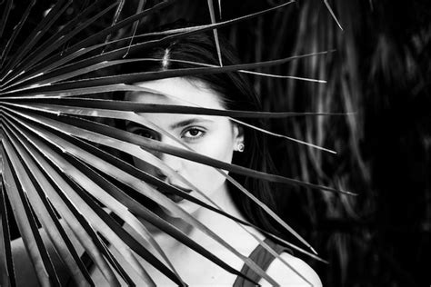 Premium Photo Sexy Beautiful Woman Hiding Behind The Palm Leaves