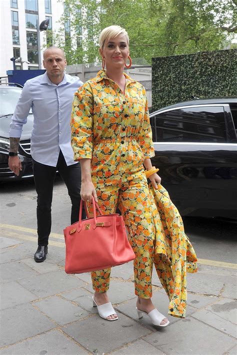 Katy Perry Wears A Bright Yellow Floral Print Jumpsuit As She Steps Out In London Uk