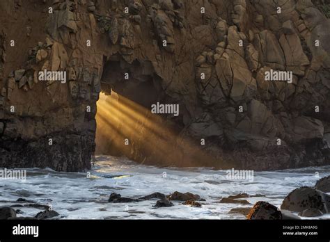 The Setting Sun Shining Through Keyhole Arch At Pfeiffer Beach Big Sur
