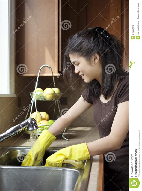 Teen Girl Washing Dishes At Kitchen Sink Royalty Free