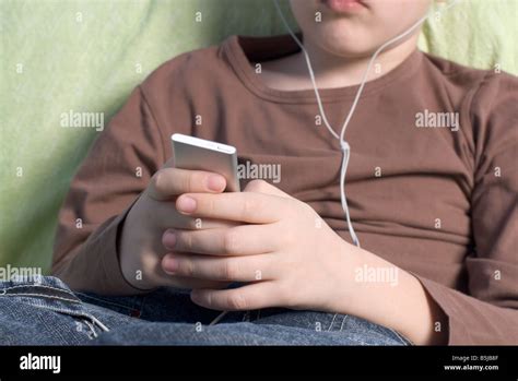 Boy Listening To Music On Ipod Stock Photo Alamy