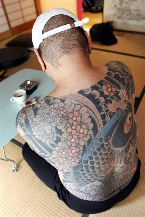japanese yakuza boss caught after tattooed photos go viral