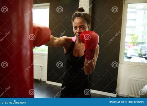 Young African Woman Boxer Wearing Red Boxing Gloves Hitting A Punching