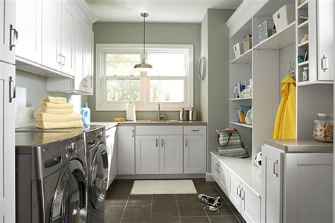 There are designated spaces for rolling carts, and an open space for storing laundry. Organize Your Laundry Room In Style