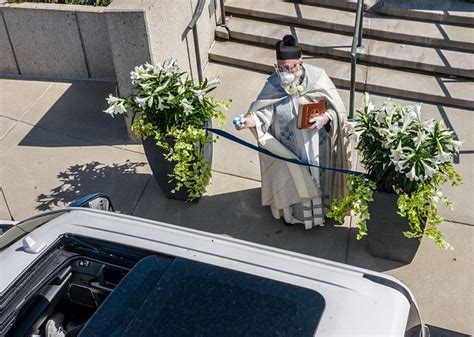 Michigan Priest Administers Holy Water With A Squirt Gun